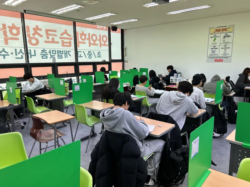 전국학원 책상에서 교재를 살펴보는 학습 공간